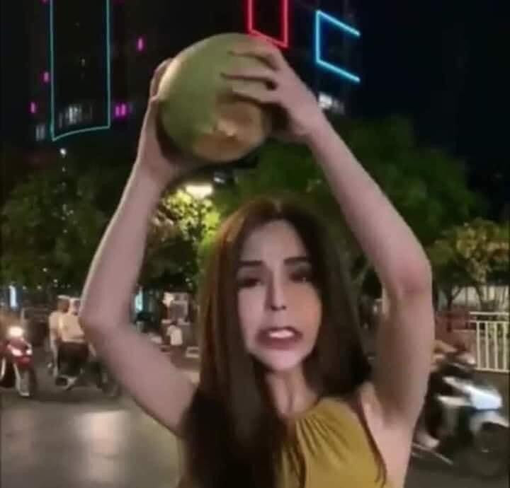 Cẩm Lan Sục (Linda) cầm quả dừa ném